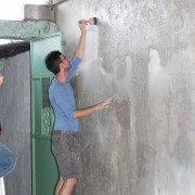 The AU team cleaning and priming the walls.